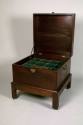 Bottle case with bottles and stoppers,
Phillip Bell (Maker), 
c. 1760,
Mahogany, spruce, bra ...